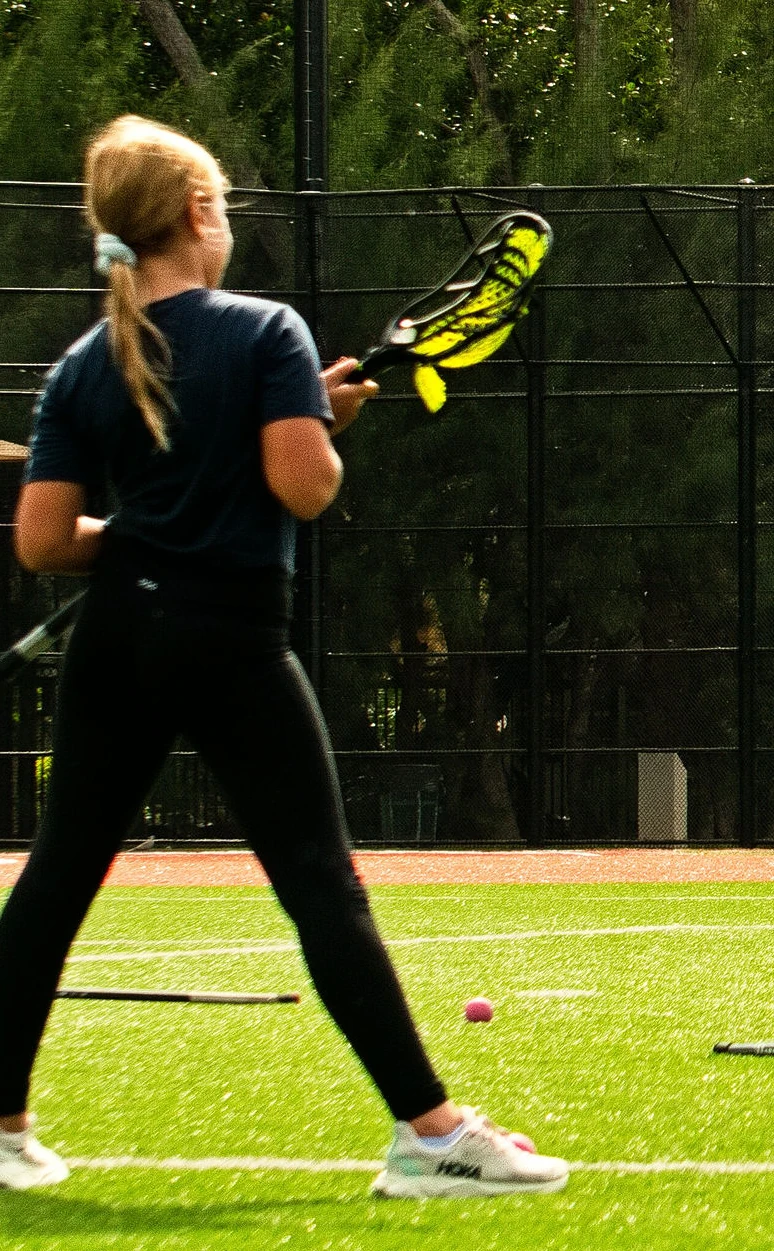 Girl preparing to practice with her lacrosse stick